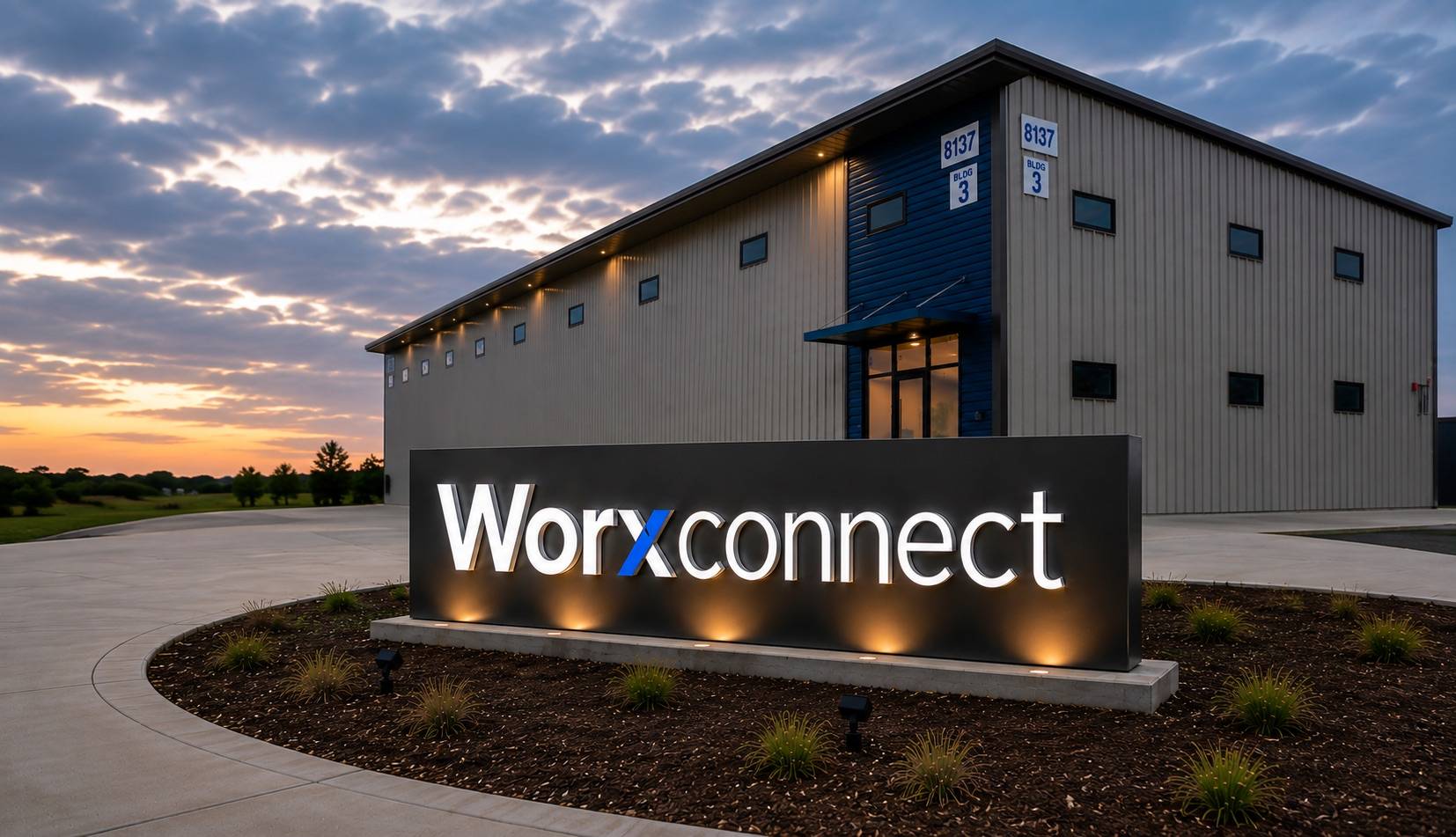 The illuminated WORX-CONNECT monument sign in front of Building 3 at 8137 Florance Road, at dusk